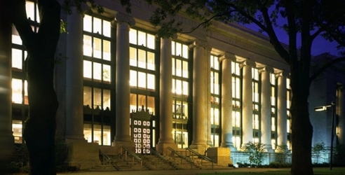 A photograph of the Harvard Law building at night.
